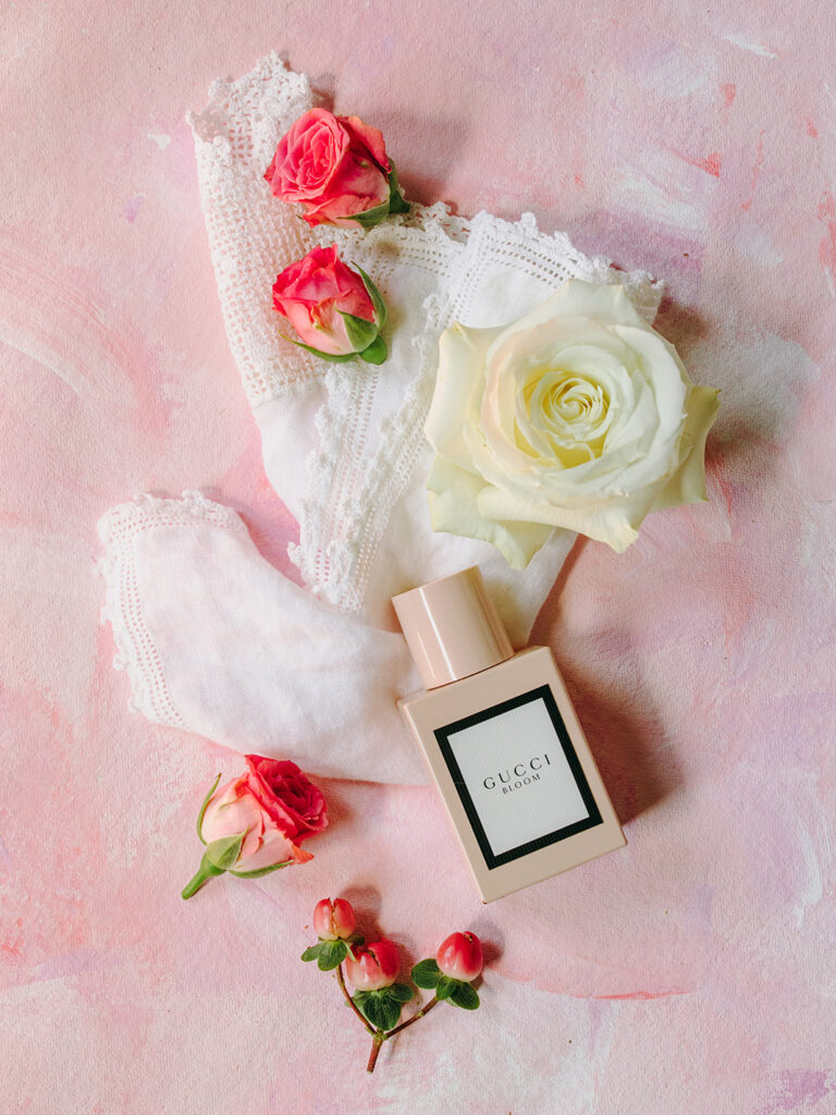 wedding flat lay with painted pink canvas as a background